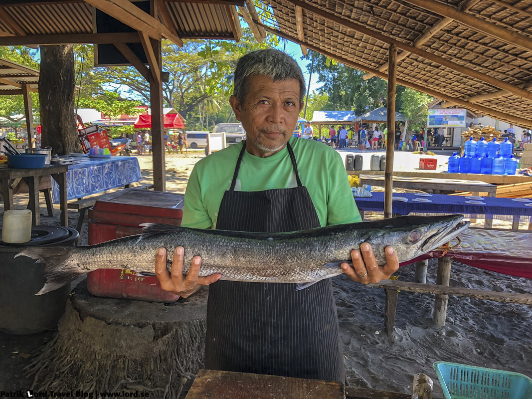Fisherman with his catch, Malatapay market, Apo Island, Philippines © Patrik Lord Travel Blog